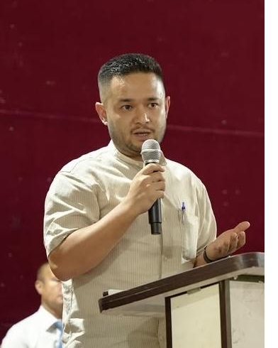Aditya Golay speaking at a lectern